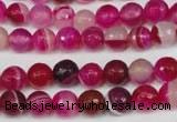 CAG2085 15.5 inches 6mm faceted round fuchsia line agate beads